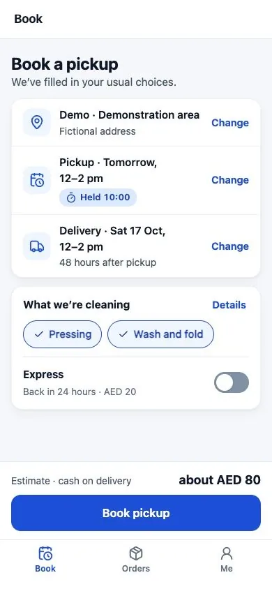 The laundry booking screen, rendered locally against fictional API responses, shows a demonstration address, pickup and delivery choices, selected services and a cash-on-delivery estimate.